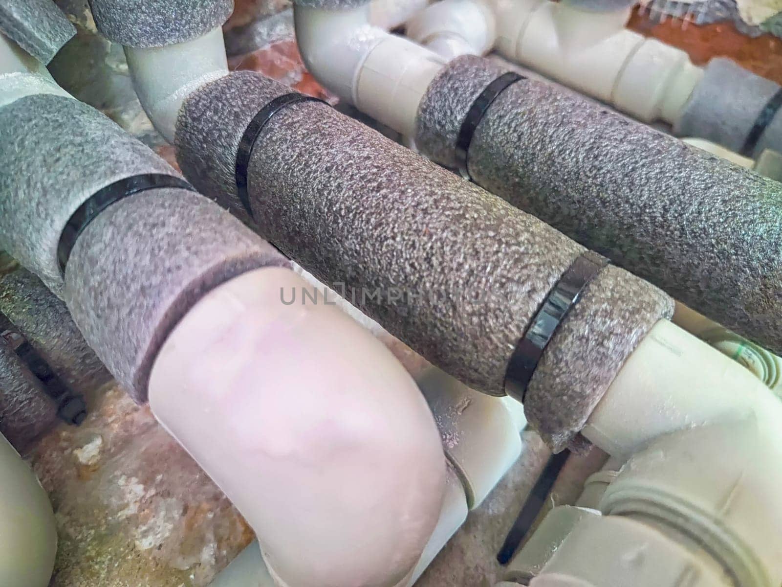 Complex Network of Insulated Pipes in an Industrial Setting. maze of thermally insulated pipes arranged in a complex network, part of an industrial heating or cooling system