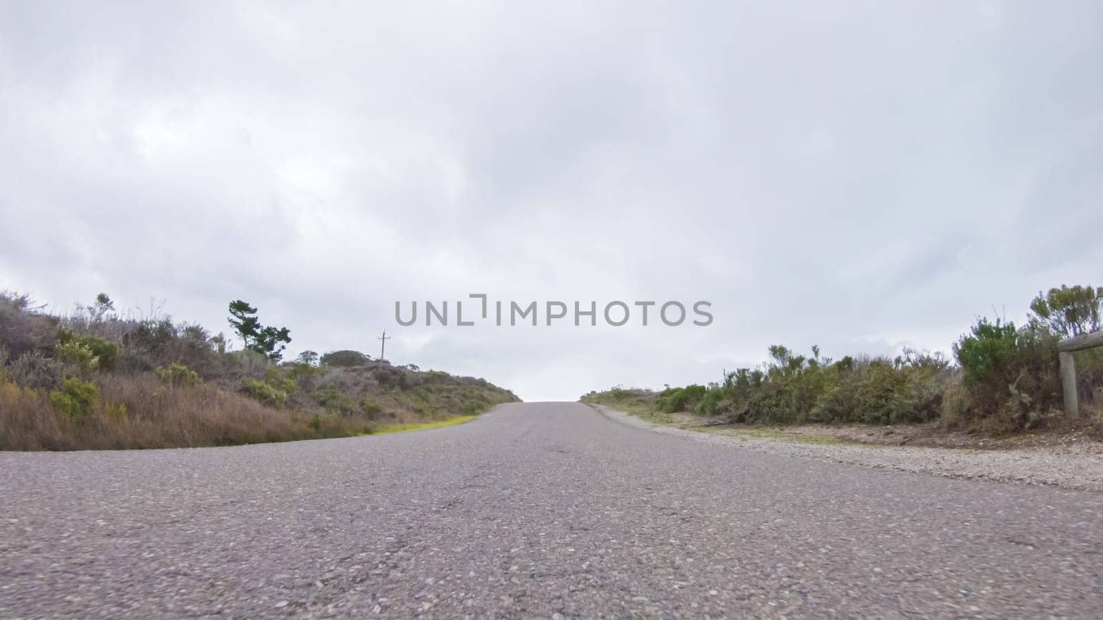 In this serene winter scene, a vehicle carefully makes its way along Los Osos Valley Road and Pecho Valley Road within Montana de Oro State Park.