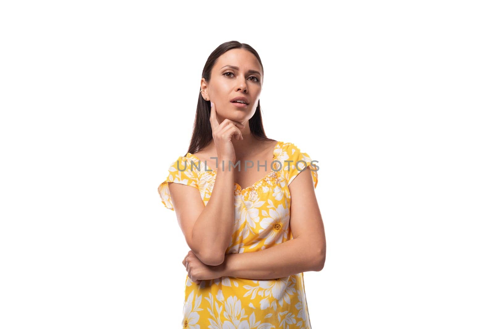 european confident brunette lady with loose hair wearing a yellow t-shirt on a white background with copy space.