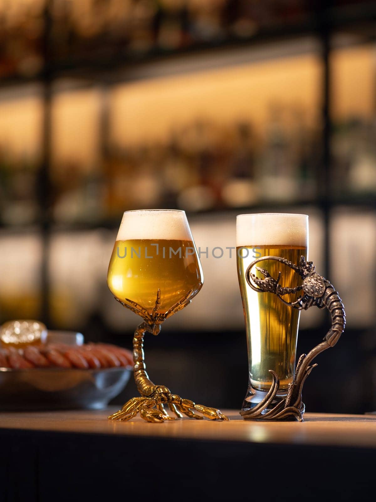 Two glass of cold light beer on bar counter. Two luxury glass with fresh cold beer on pub desk with copyspace for text. Octoberfest background. Vertical