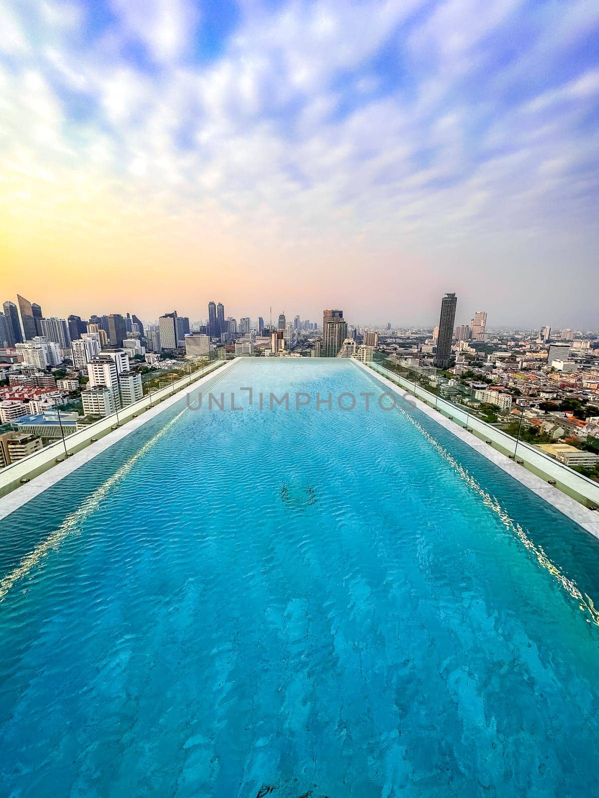 Rooftop pool with Bangkok skyline view at sunset, in Bangkok Thailand, south east asia