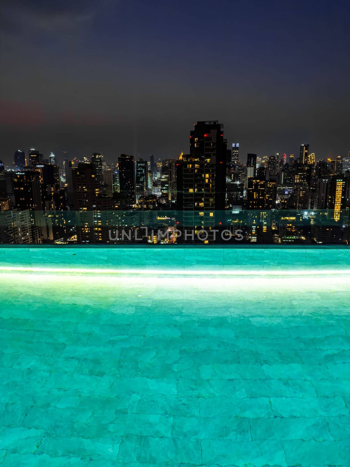 Rooftop pool with Bangkok skyline view at sunset, in Bangkok Thailand, south east asia