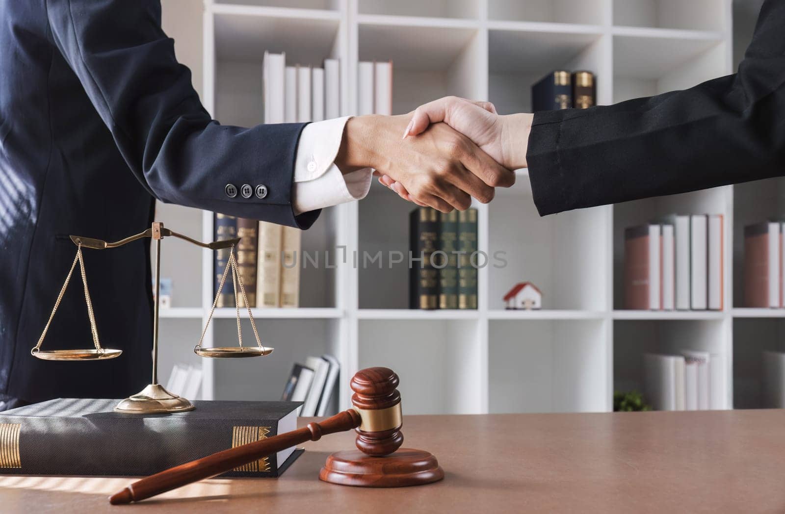 legal advice A lawyer shakes hands with a client after a successful consultation. by wichayada