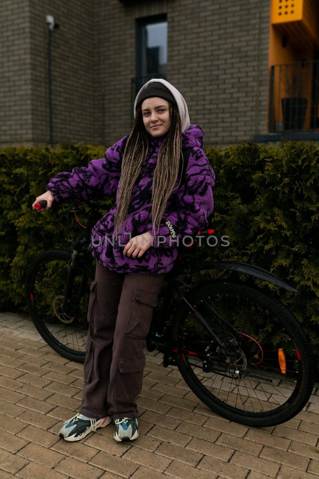 Bicycle rental concept. Young woman riding a sports bike around the city.