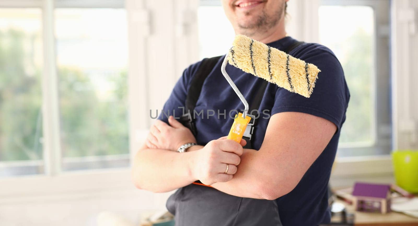 Arm of smiling worker hold brush closeup by kuprevich