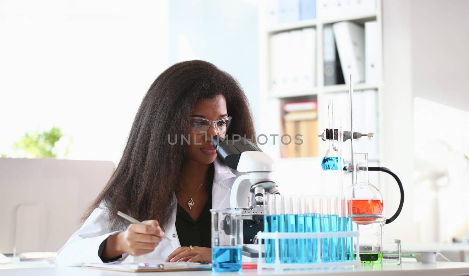 Black woman scientist student chemist in protective by kuprevich