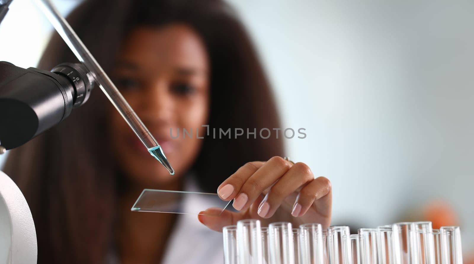 A male chemist holds test tube of glass by kuprevich