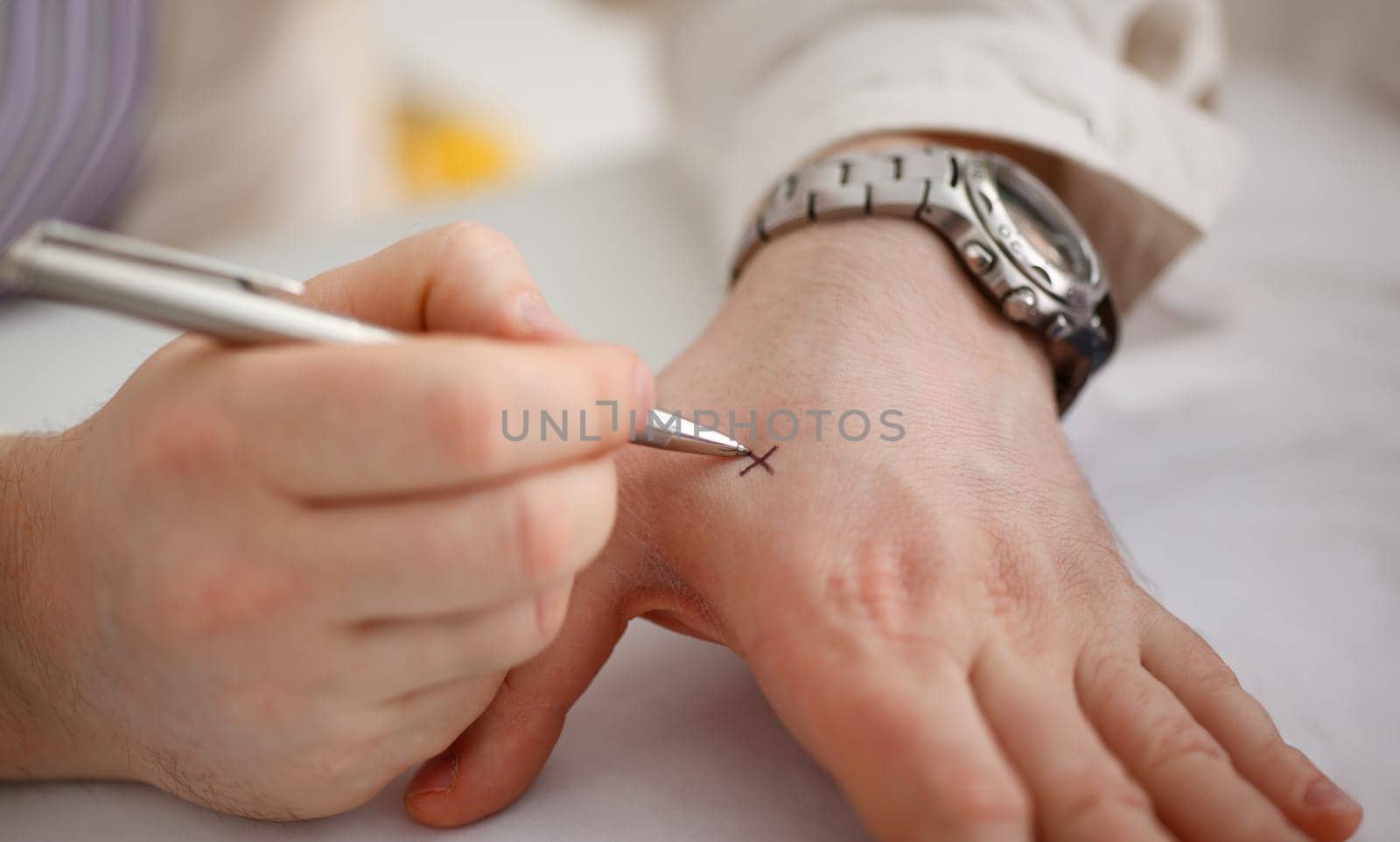 Male make x cross note with silver pen at his arm by kuprevich