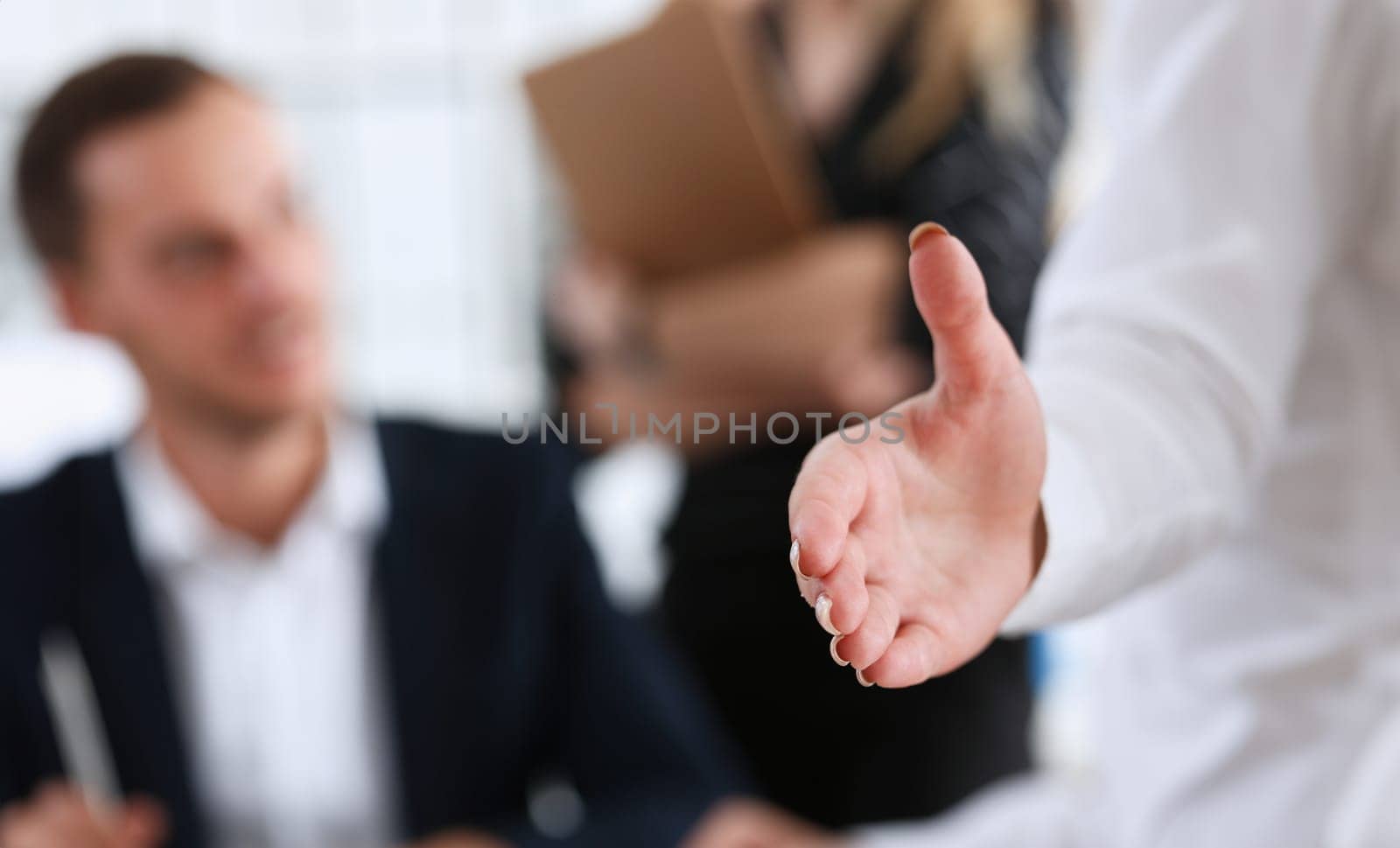 Businesswoman offer hand to shake as hello in office closeup. Serious solution friendly support service excellent prospect introduction or thanks gesture gratitude invite to participate concept