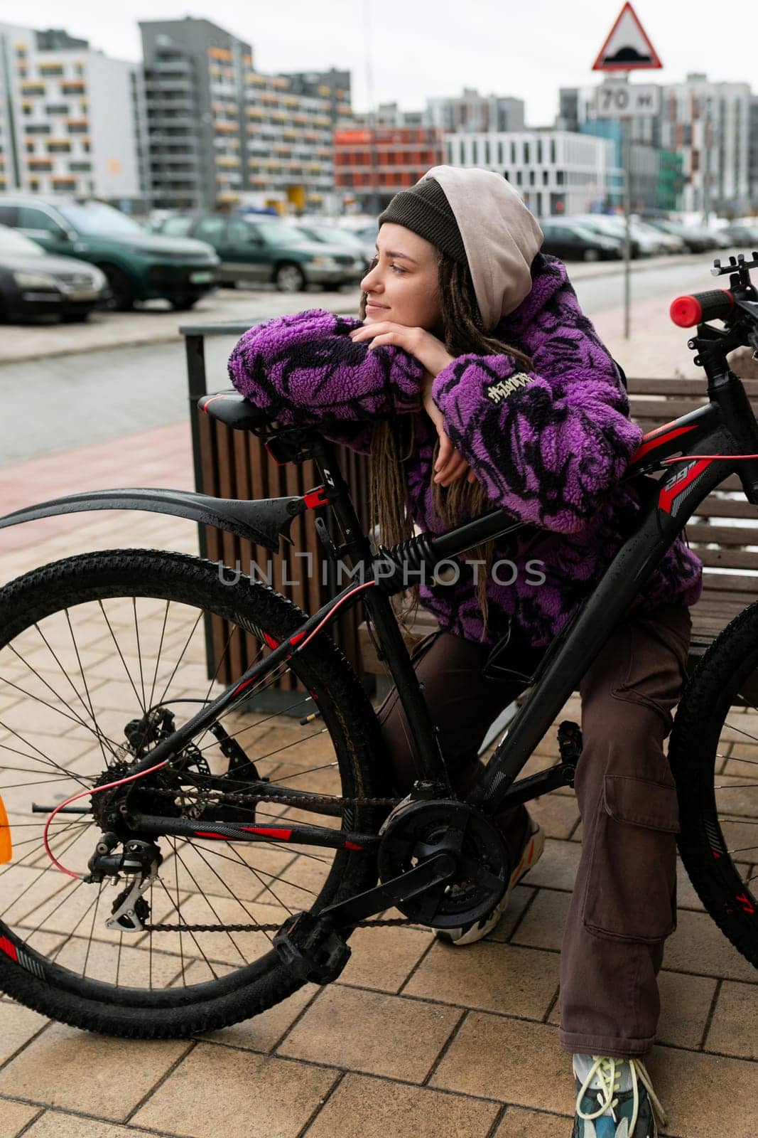 Lifestyle concept. Young woman walking around the city with a bicycle.