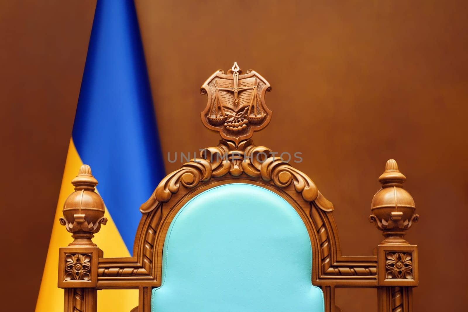 Empty chair judge Ukraine flag in courtroom background. Constitutional Court of Ukraine law justice system. Trial court scales of justice symbol Ukraine justice reform