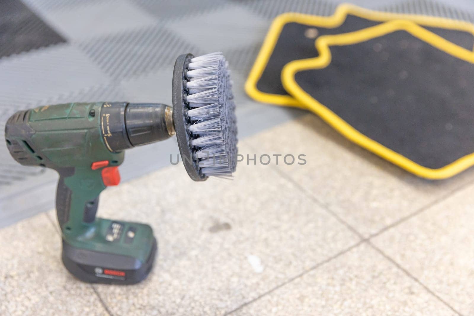 Automatic hand brush for cleaning car mats, vehicle clean concept by Kadula