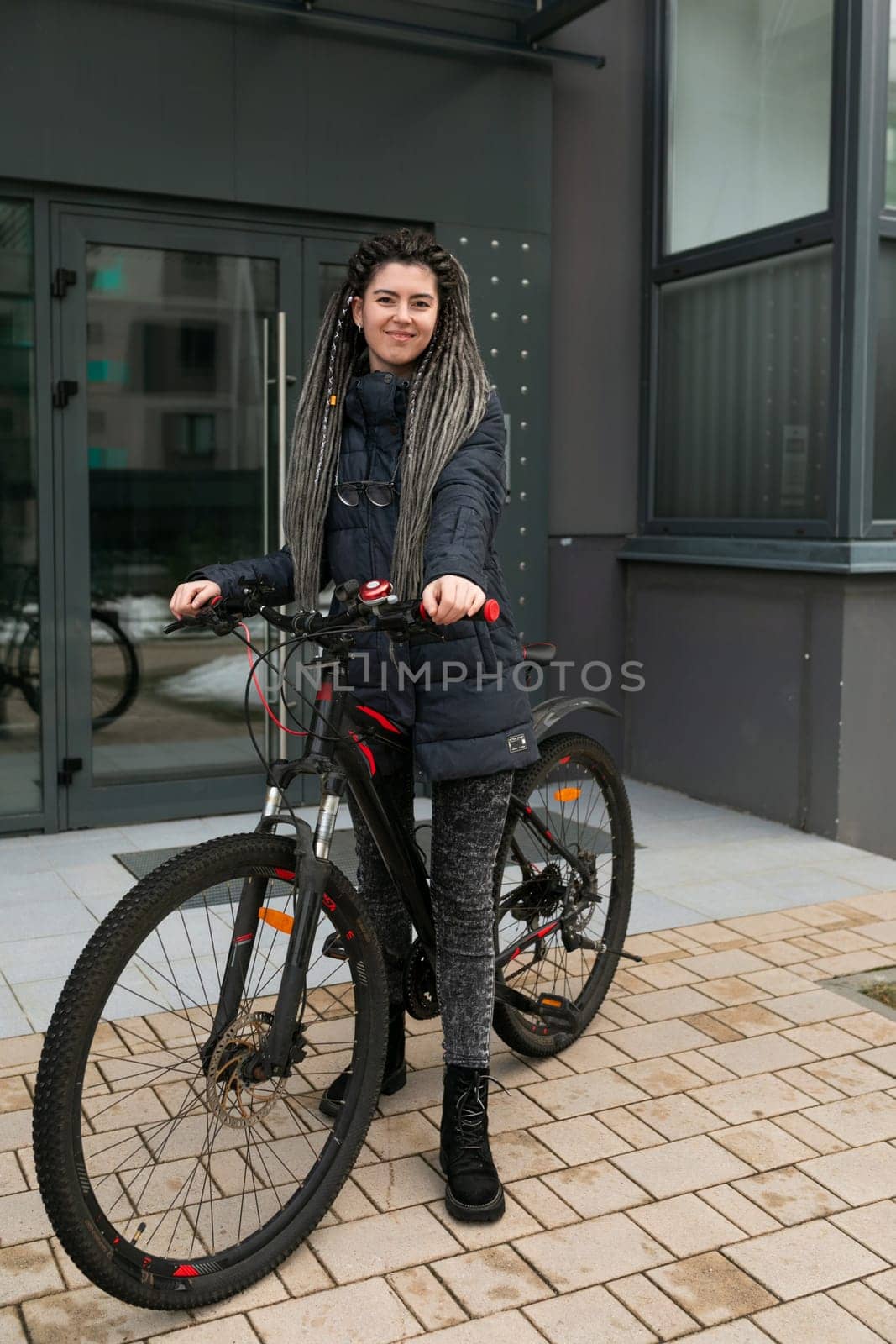 Bike rental concept, young caucasian woman riding a bike on the street.