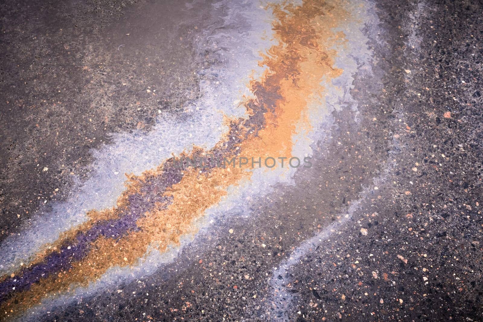 A colorful stain of engine oil on the road.