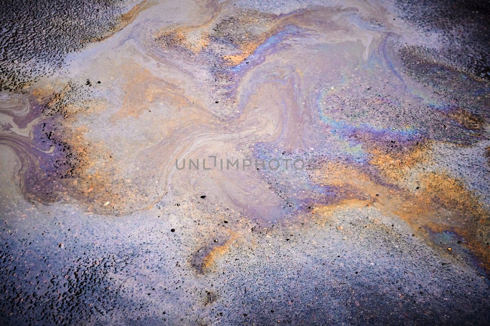 Oil stain on Asphalt, color Gasoline fuel spots on Asphalt Road as Texture or Background.