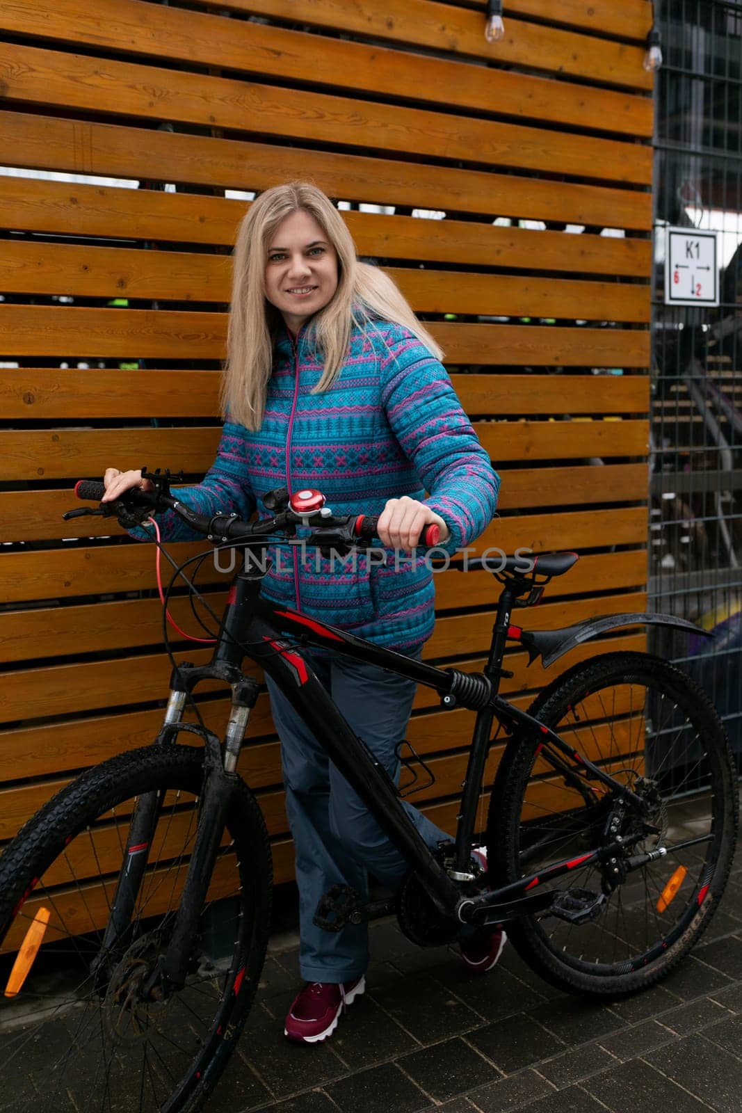 European woman with blond hair went out for a bike ride in winter by TRMK