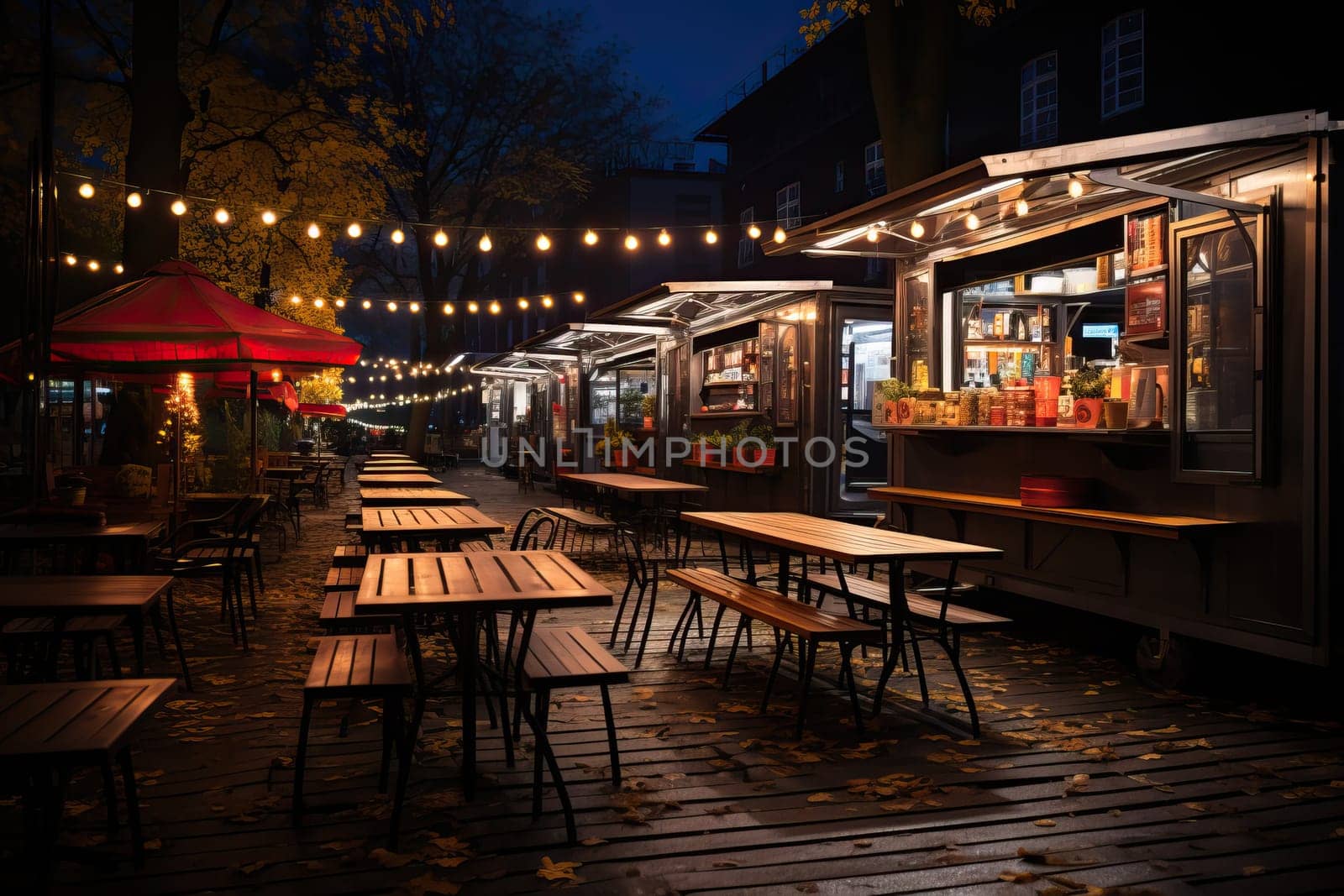 Empty Scene with a Dark Street Food Van Standing in the Evening in a Nice Warmly Lit . An empty food stall on a street lit with garlands. by Niko_Cingaryuk