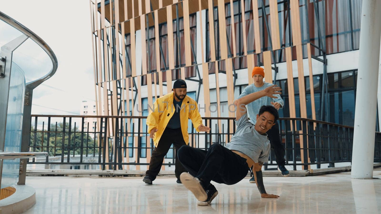 Hip hop team dance break dance while multicultural friend surrounded and clapping hands to cheer or encourage his friend to dance. Active and energetic street dance. Outdoor sport 2024. Endeavor.