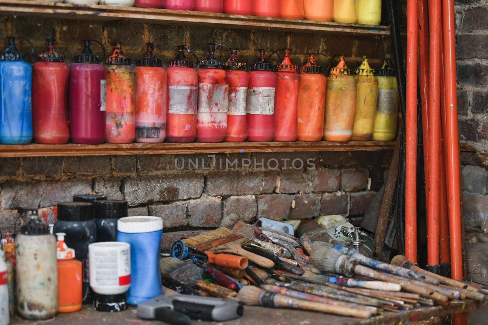 Jars with acrylic paints at a workshop of artist