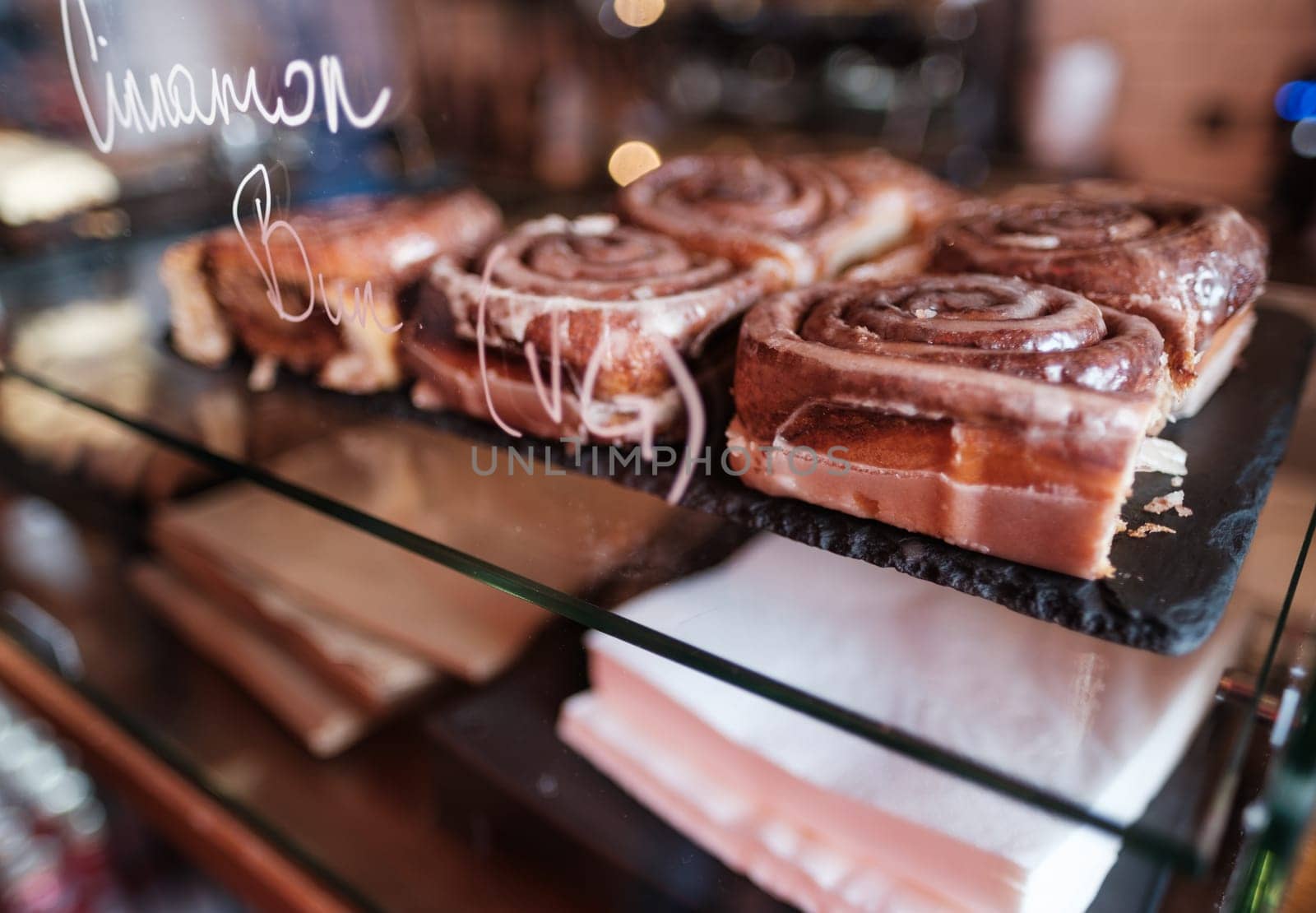 Some Delicious Cinnamon Buns (Rolls) In A Trendy Cafe Or Bakery
