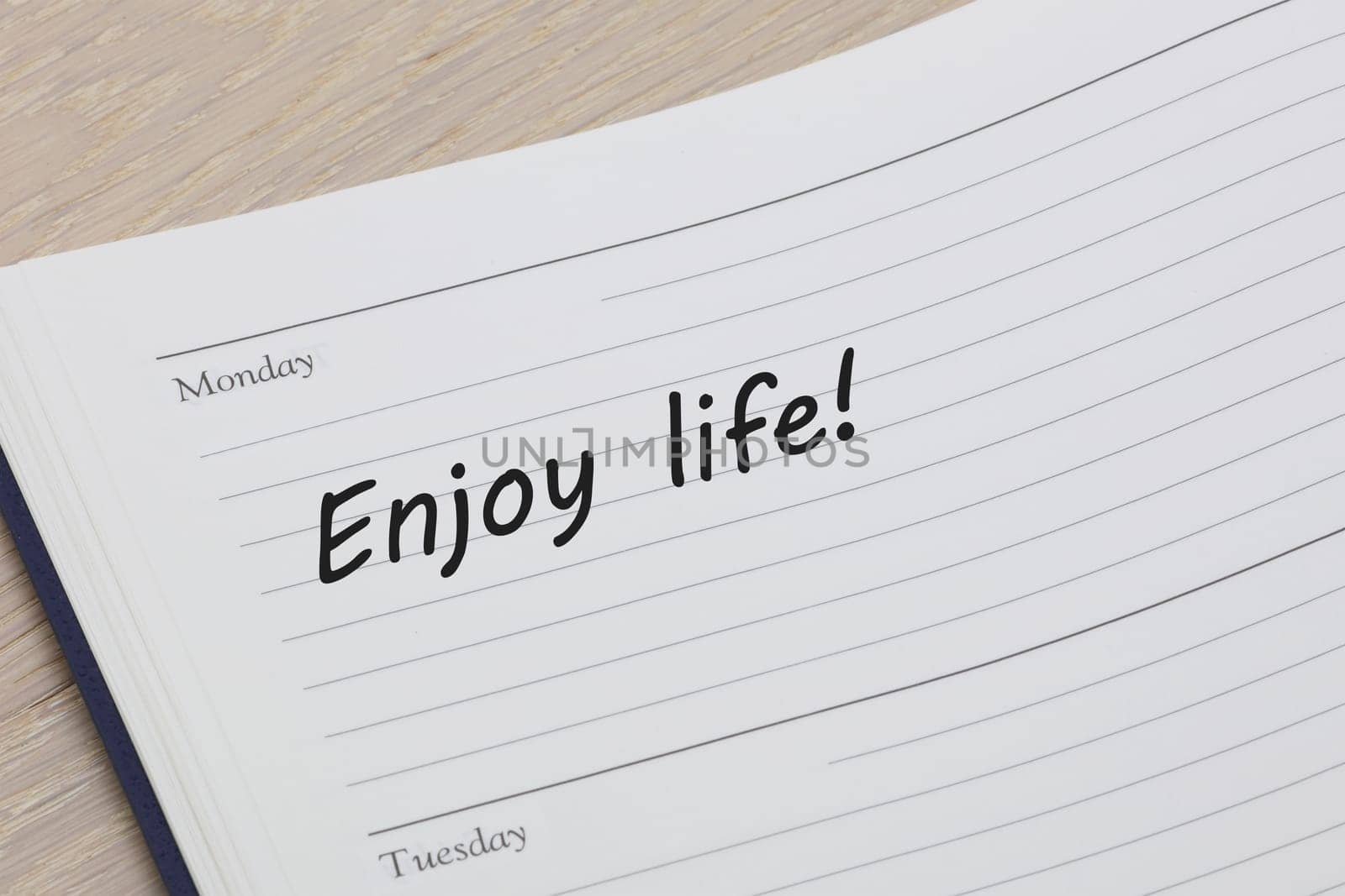 An Enjoy life reminder message in an open diary