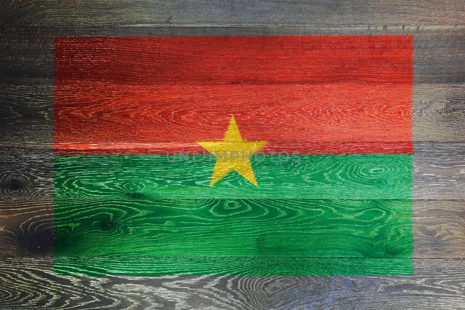 Burkina flag on rustic old wood surface background by VivacityImages