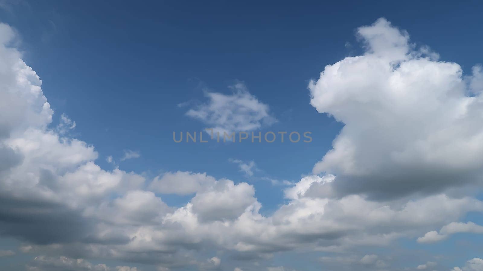 Heavenly white clouds on the blue sky with the sun appeared perfect for multimedia texture or background and content creation