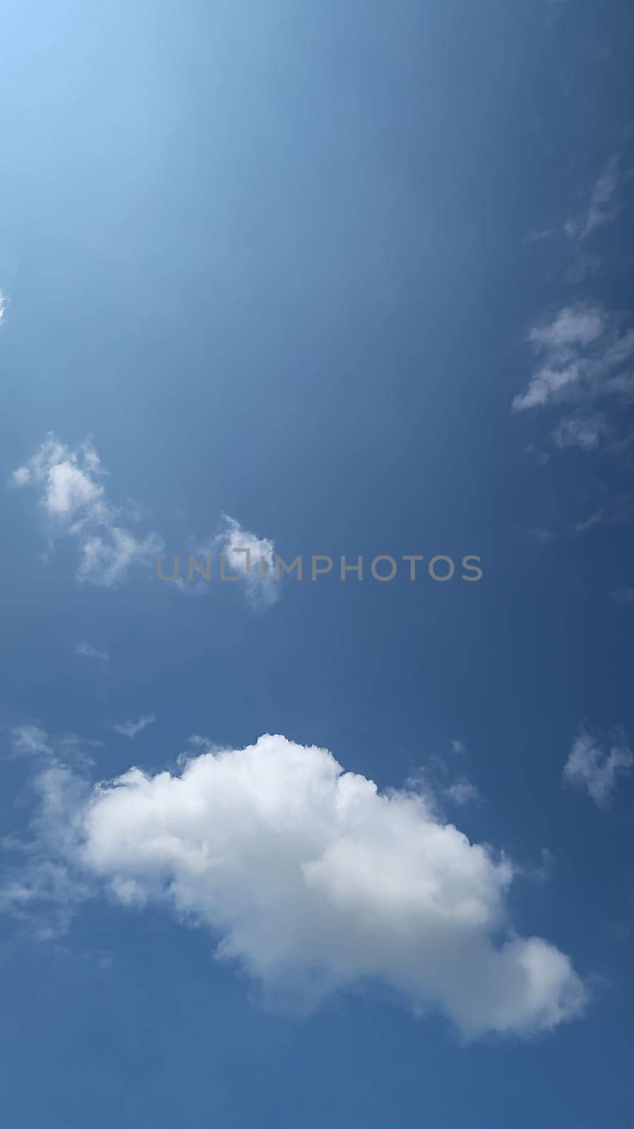 Heavenly white clouds on the blue sky with the sun appeared perfect for multimedia texture or background and content creation