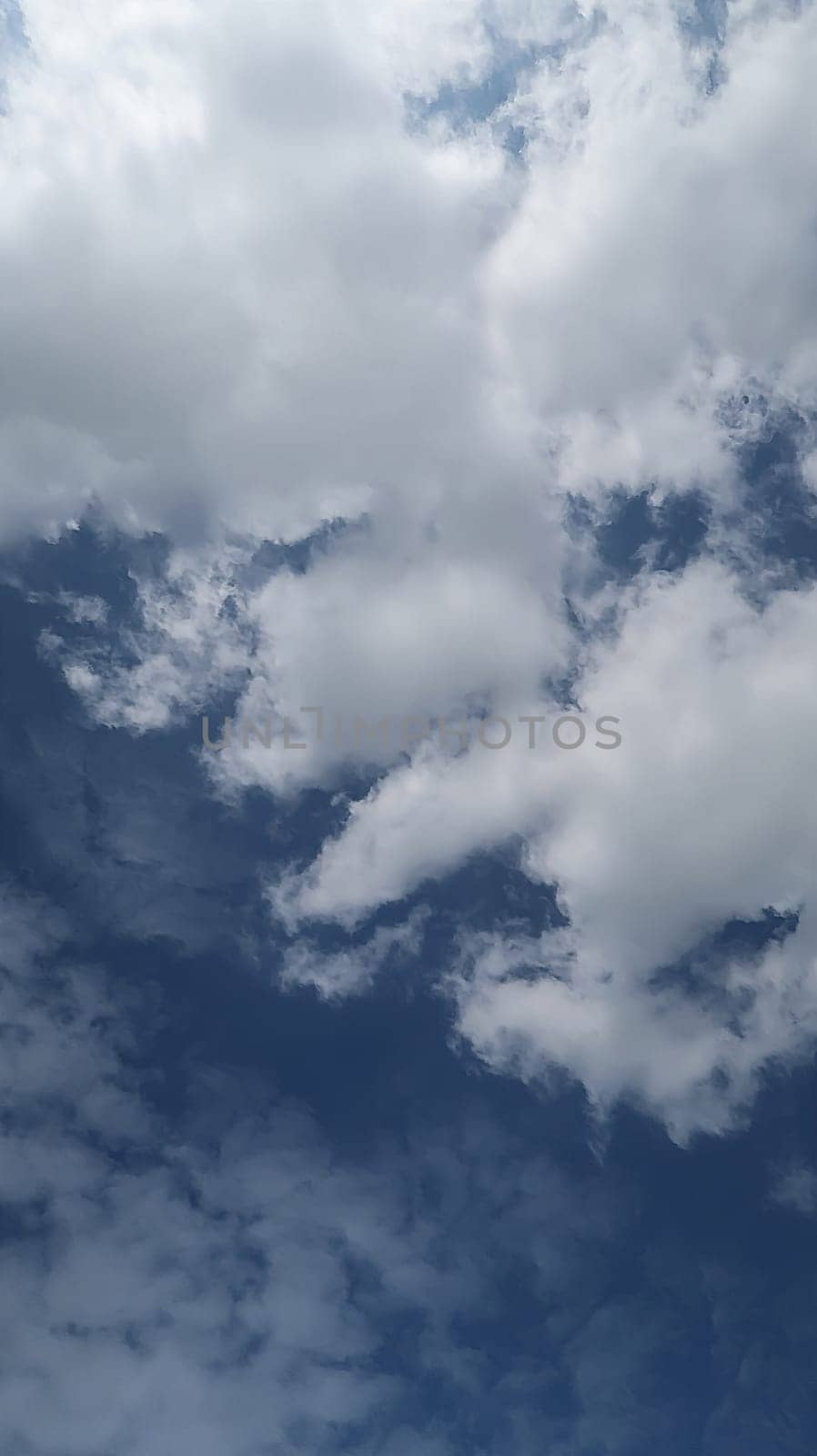 Heavenly white clouds on the blue sky with the sun appeared perfect for multimedia texture or background and content creation