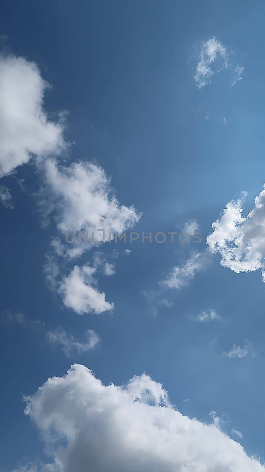 Heavenly white clouds on the blue sky with the sun appeared perfect for multimedia texture or background and content creation