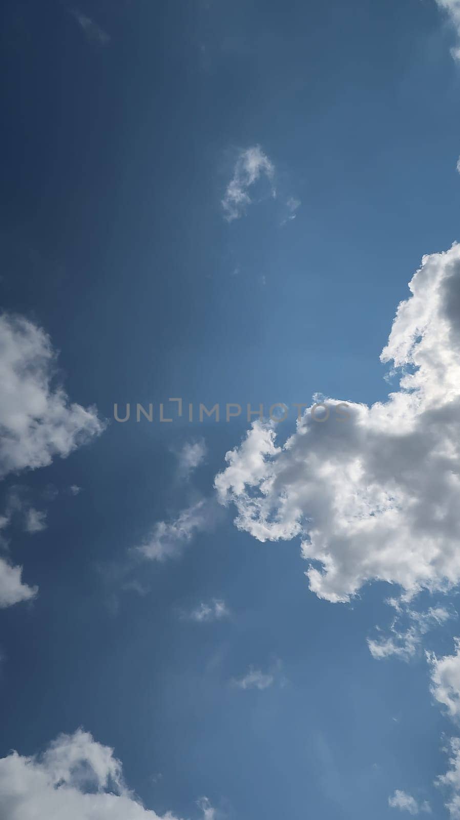 Heavenly white clouds on the blue sky with the sun appeared perfect for multimedia texture or background and content creation