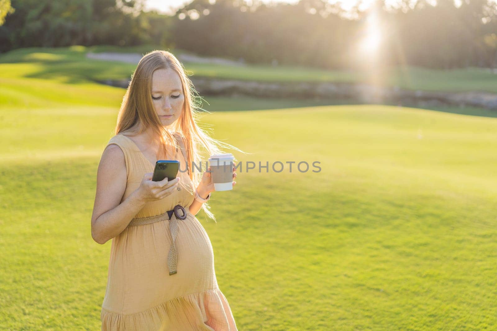 pregnant woman enjoys a cup of coffee outdoors, blending the simple pleasures of nature with the comforting warmth of a beverage during her pregnancy by galitskaya