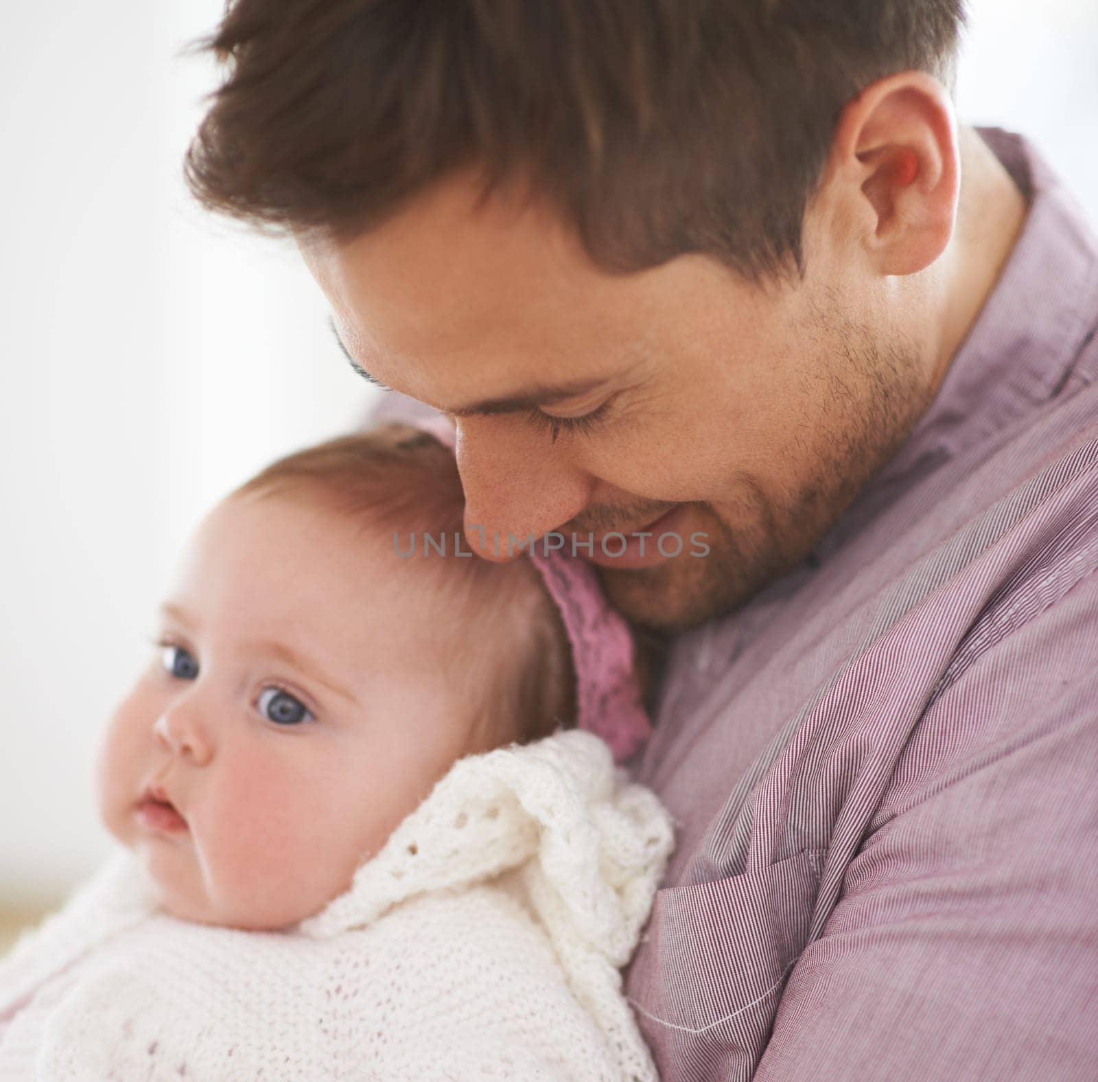 Family, baby and dad at home with love, support and care together with parent and bonding. Relax, father and happy in a house with hug of a calm infant with childcare and smile with a young girl.