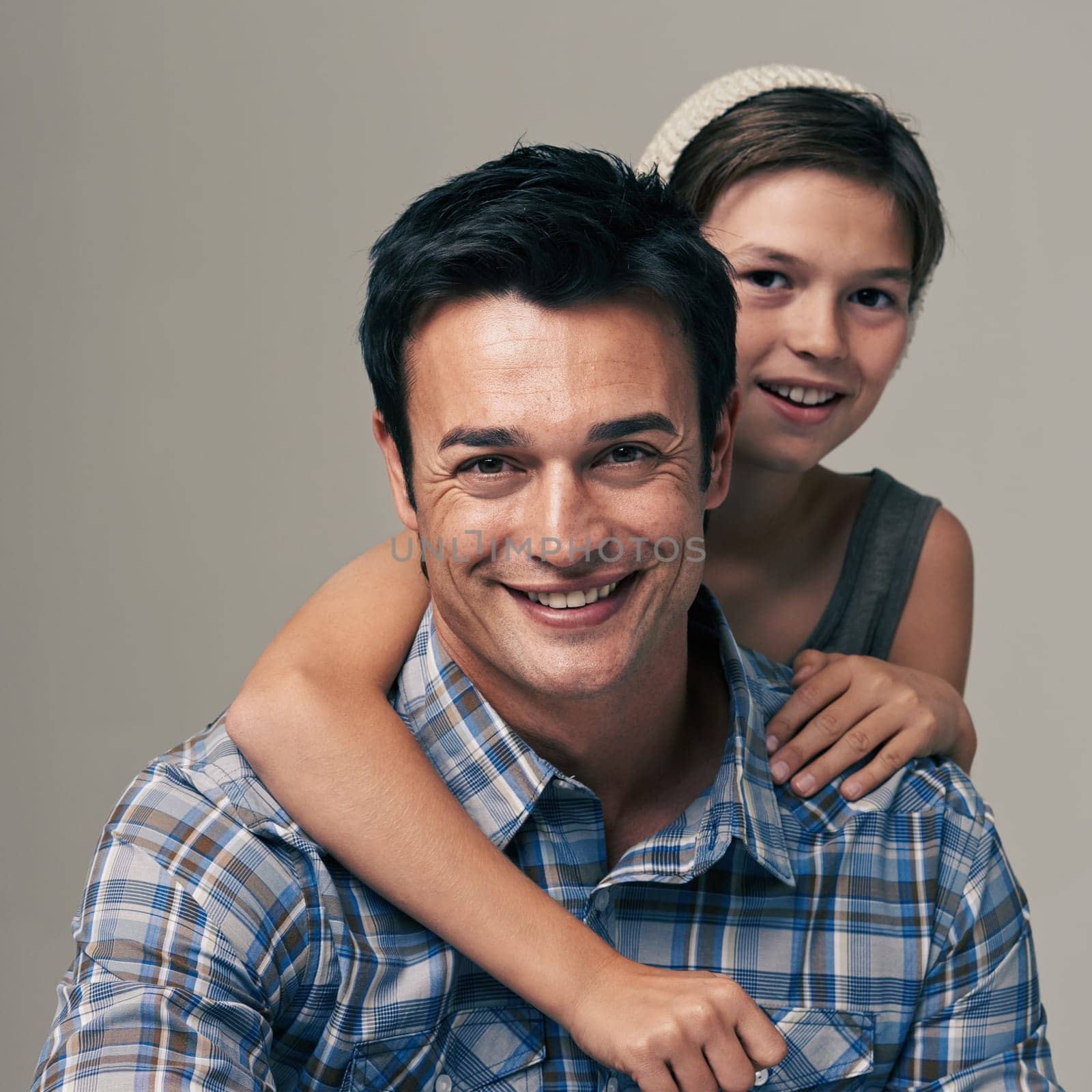 Happy father, portrait and child with hug for love, care or support in fashion on a white studio background. Face of dad, son or kid with smile in casual clothing or trust for parenting or bonding.