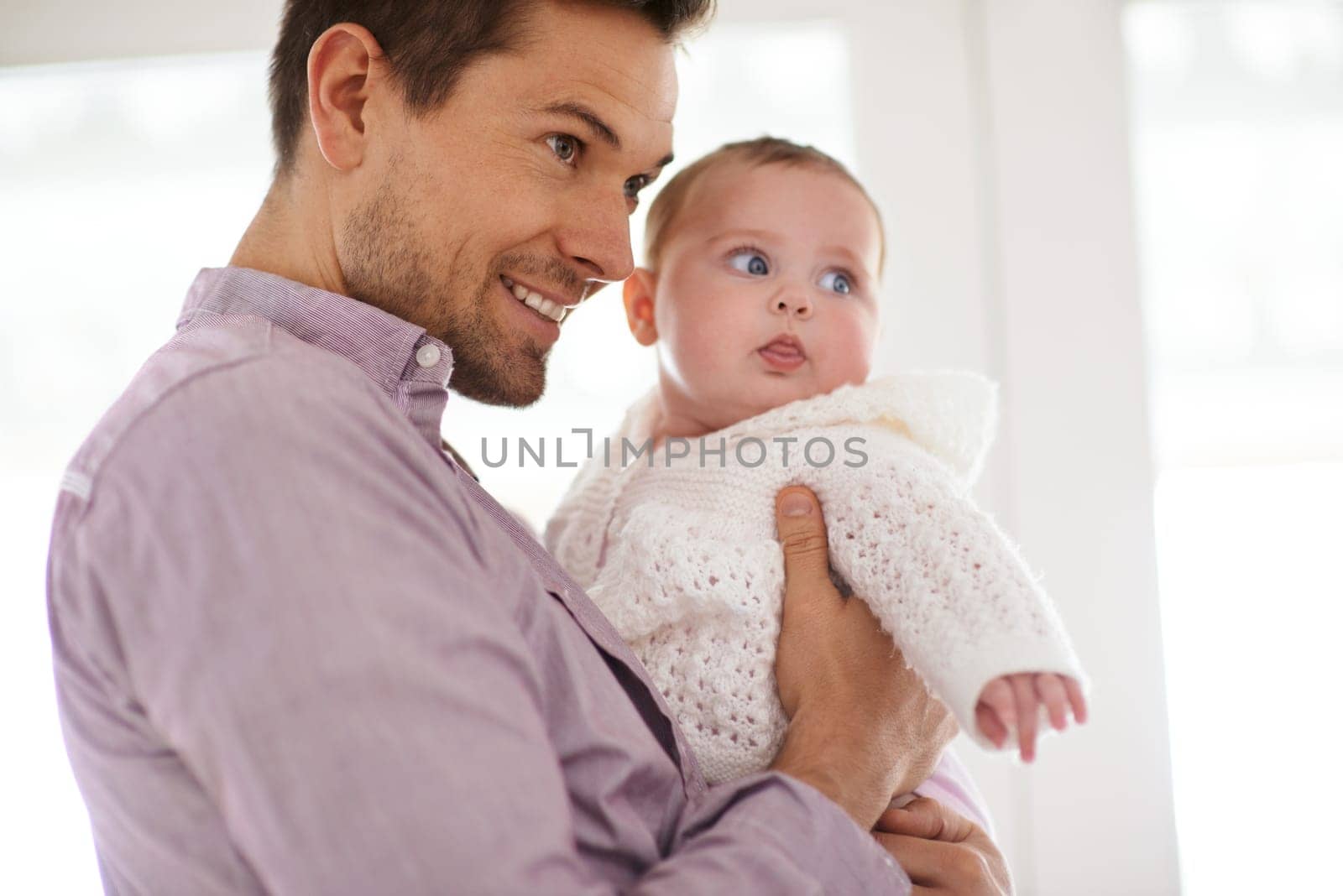 Father, baby and home with love, bonding and fun together with newborn and smile. Happy, family and dad with young child in a living room with parent care in house carrying calm infant with support by YuriArcurs
