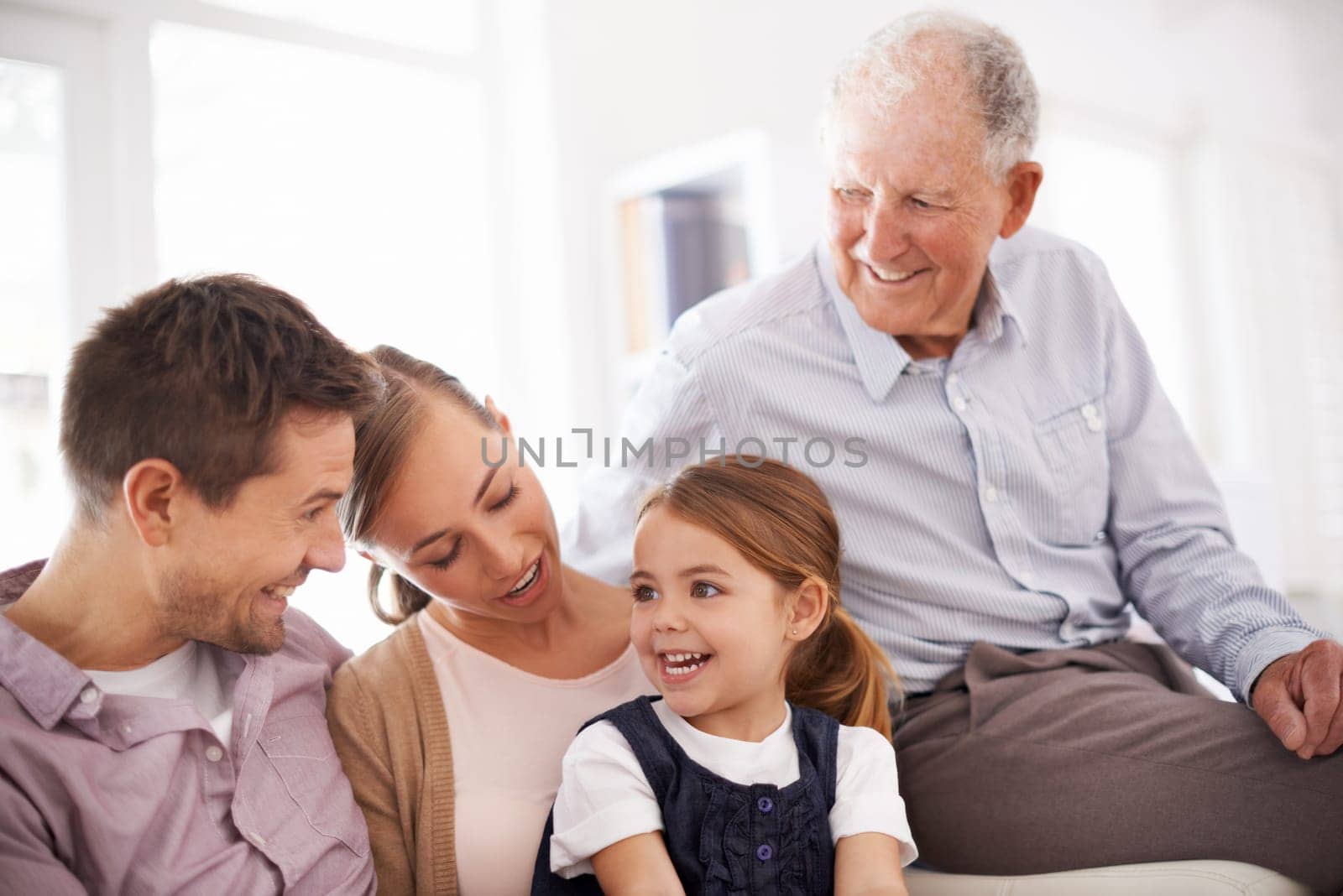 Parents, grandfather and child with happiness on sofa for healthy development, security or comfort in apartment. Family, men and woman with girl kid, smile and bonding for parenting and love in house by YuriArcurs