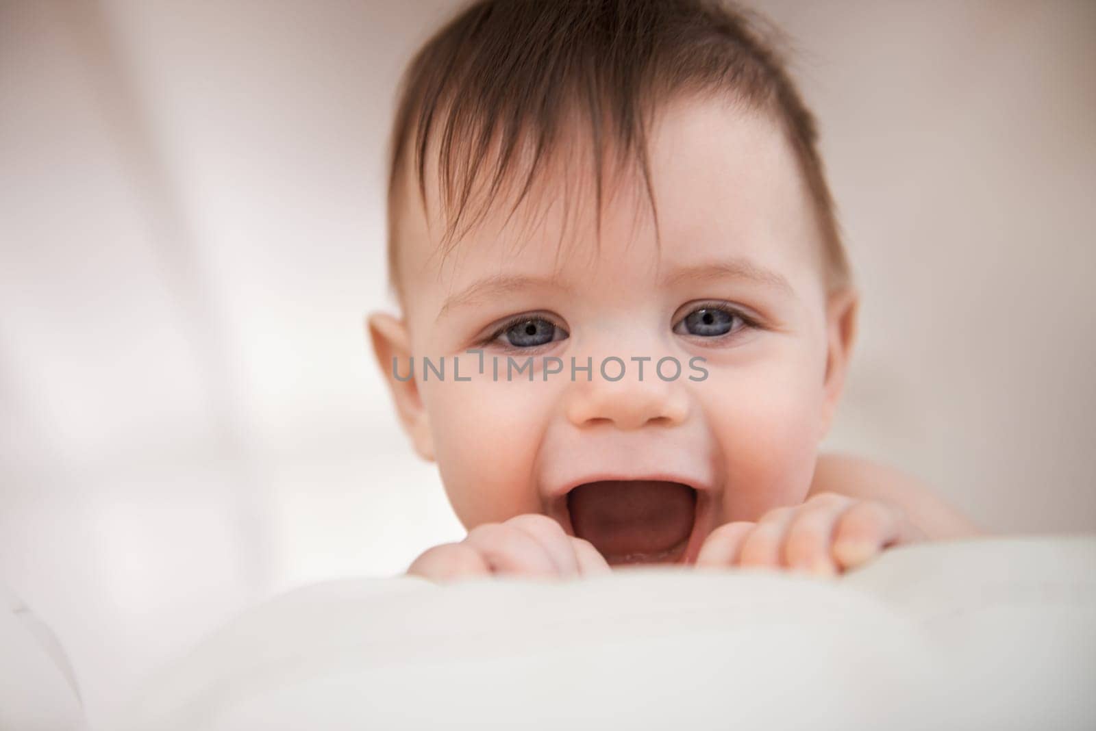 Baby boy, excited smile and happy for play, growth and development for childhood. Adorable infant, young and healthy kid at home with face expression, learning motor skills and comfortable in house.