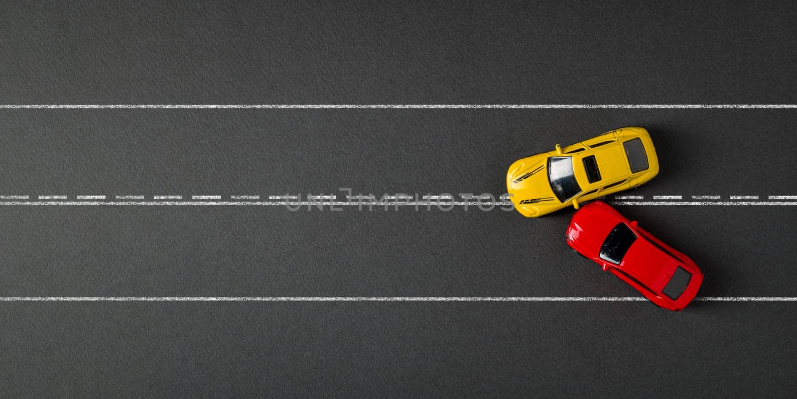 Top view of red and yellow cars colliding and crashing on dark gray background by Sonat