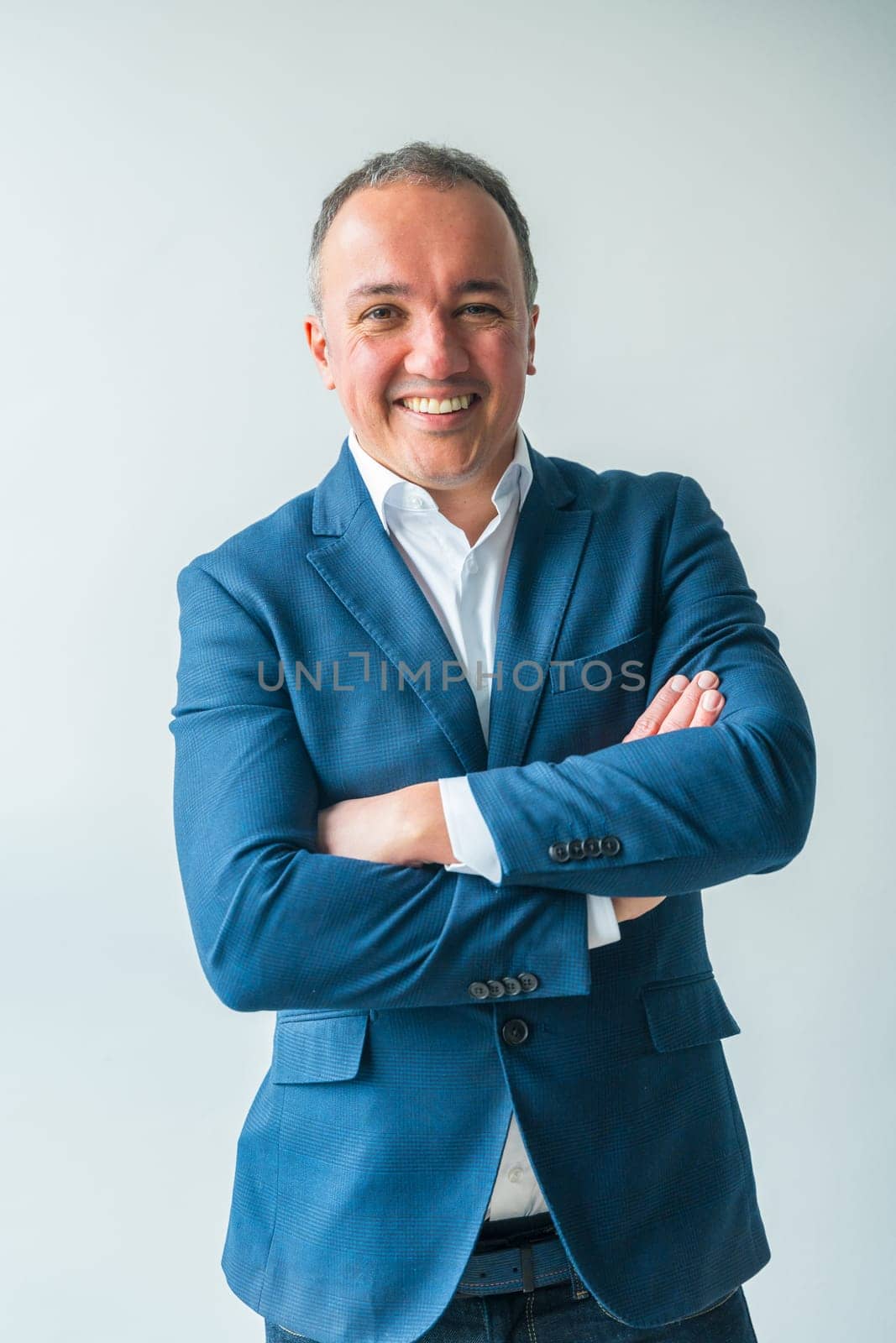 Portrait of a confident businessman standing proud with arms crossed by Huizi