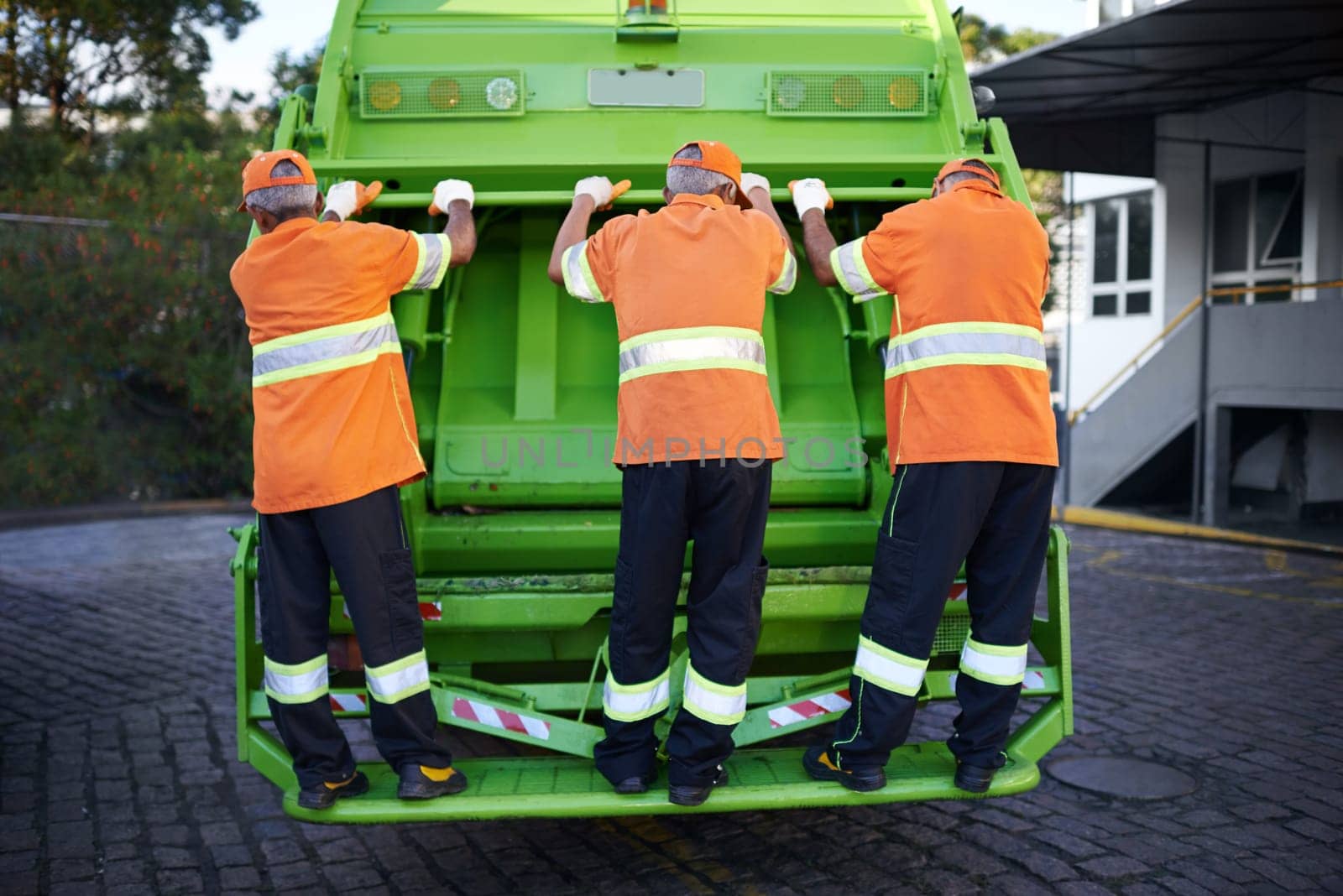 Men, garbage truck and waste collection service for city pollution for cleaning, environment or teamwork. Male people, back and dirt transportation for sidewalk debris in New York, mess or litter by YuriArcurs
