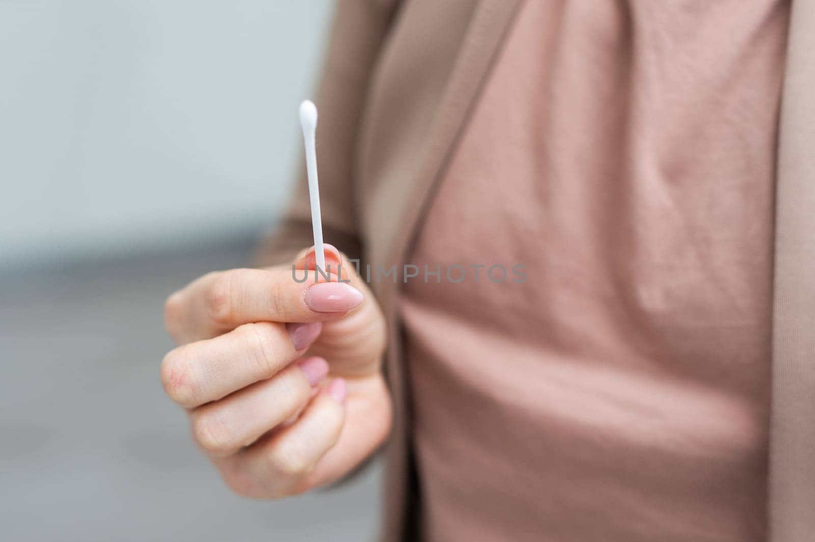 Cotton buds in hand isolated on white background. High quality photo