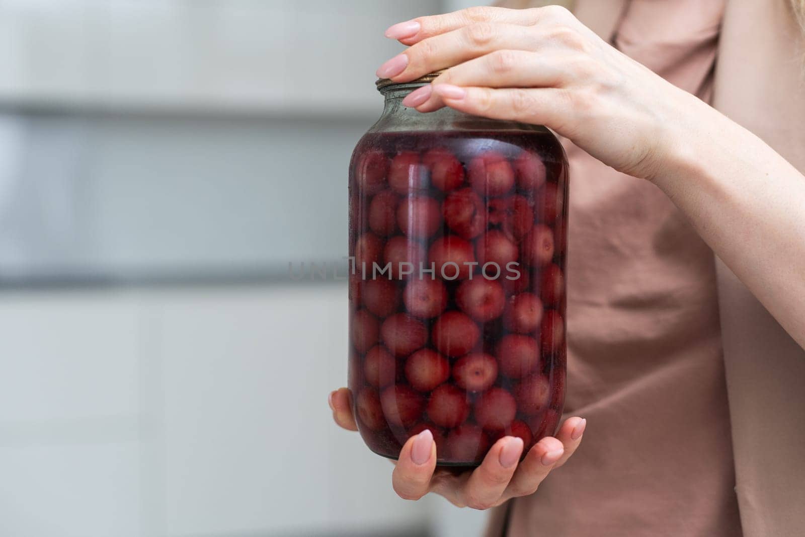 Glass jar with cherry drink and cherry. by Andelov13