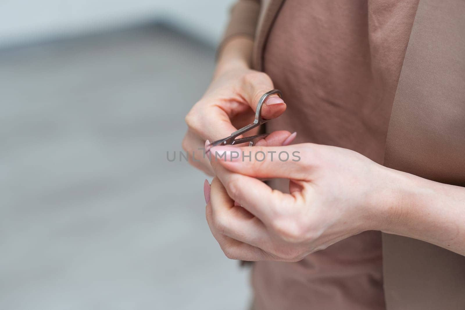 scissors in a hand on a white background. High quality photo