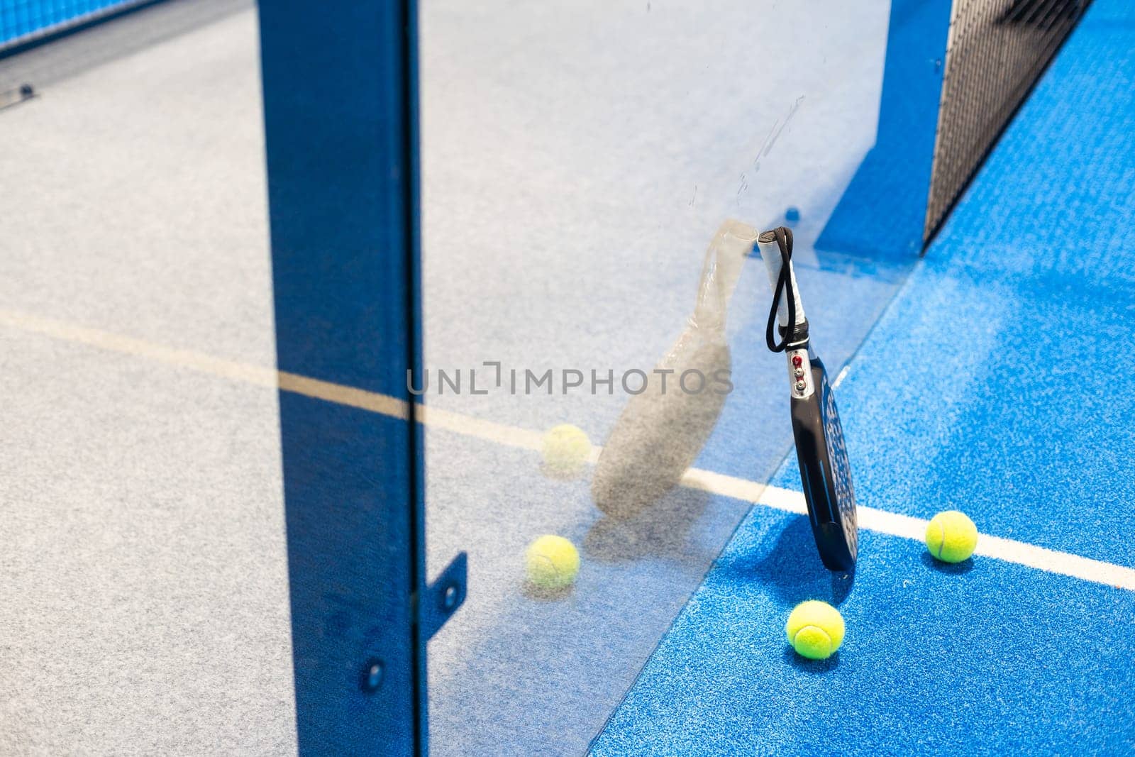 White professional paddle tennis racket with natural lighting on blue background. Horizontal sport theme poster, greeting cards, headers, website and app. High quality photo