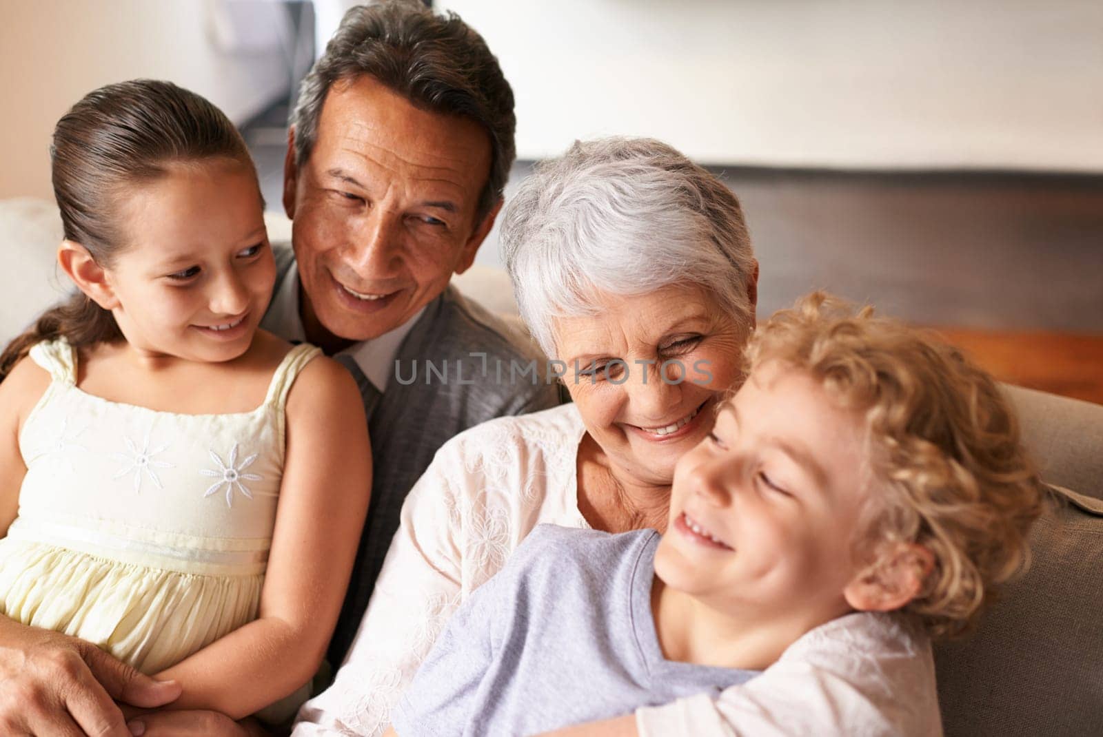Hug, grandparents and grandchildren with smile for family, photo and multi generation bonding. Senior couple, boy and girl with laugh, love and happiness for playful relationship together at home.