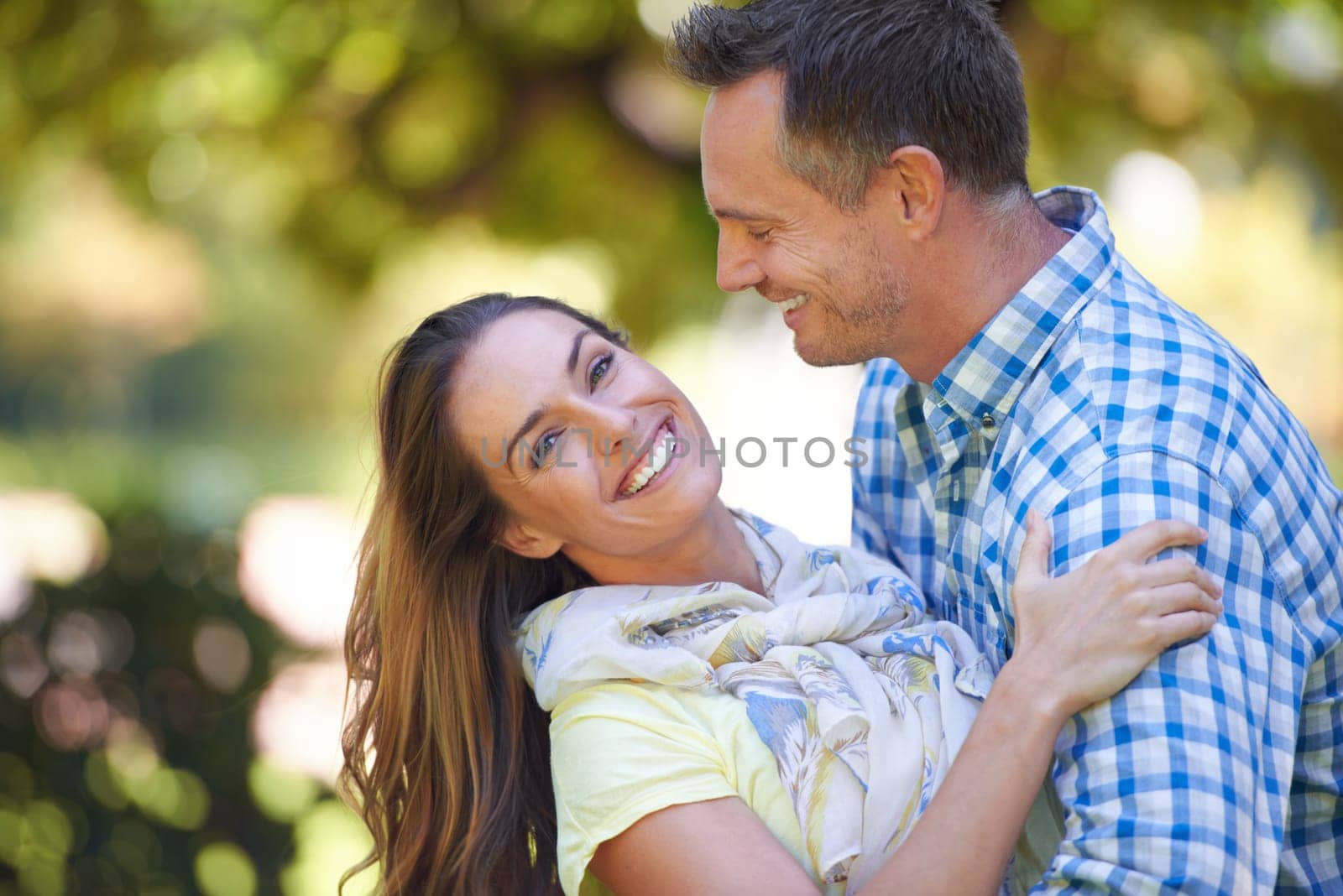 Couple, portrait and hug with care in garden together, bonding and romance for relationship with commitment. Man, woman and affection for dating with love, happy and spouse for comfort in nature by YuriArcurs