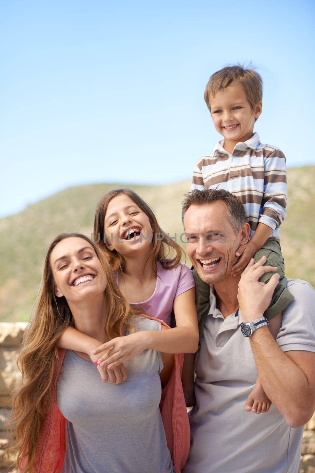 Parents, children and outdoor portrait as family or holiday connection in nature or explore park, relax or vacation. Mother, father and siblings on shoulders in Florida or travel, adventure or fun.