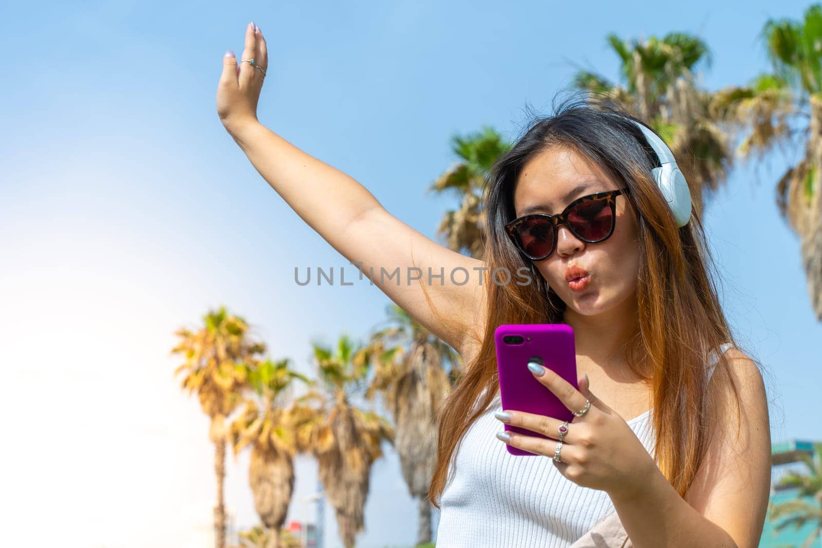 Chinese girl in headphones dancing music outdoor on summer. by PaulCarr