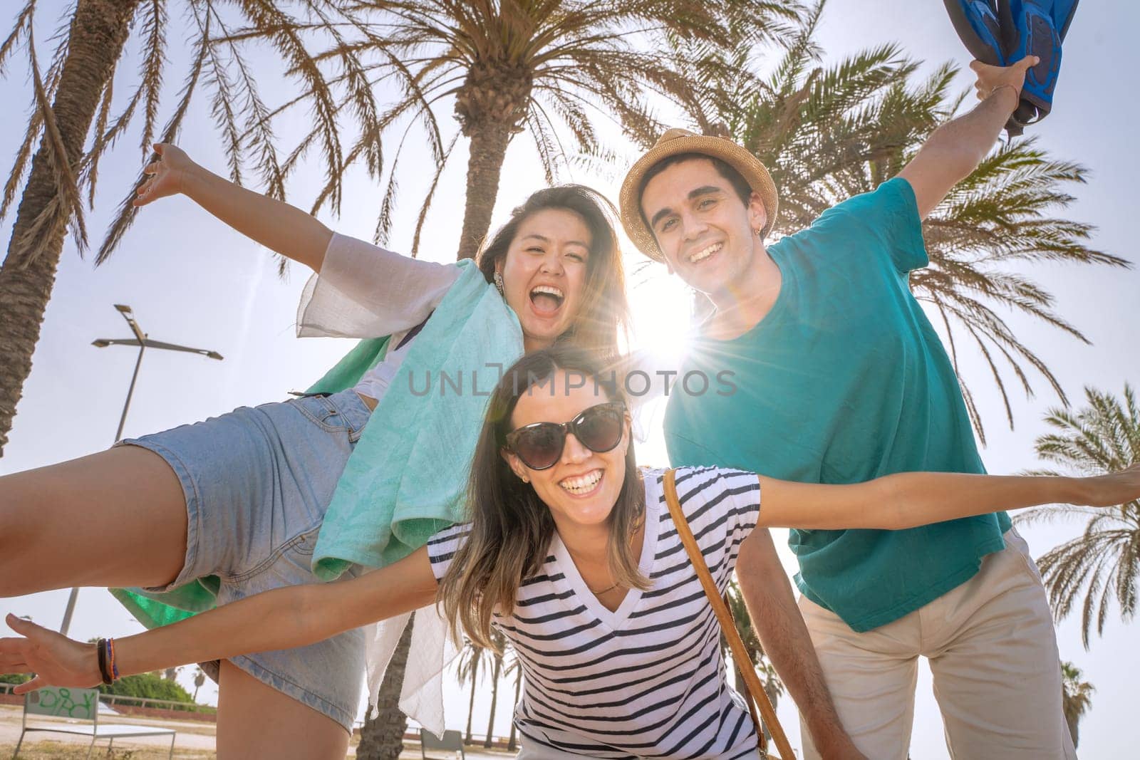 Multiracial group of friends happy laughing in the beach in summer after school. by PaulCarr