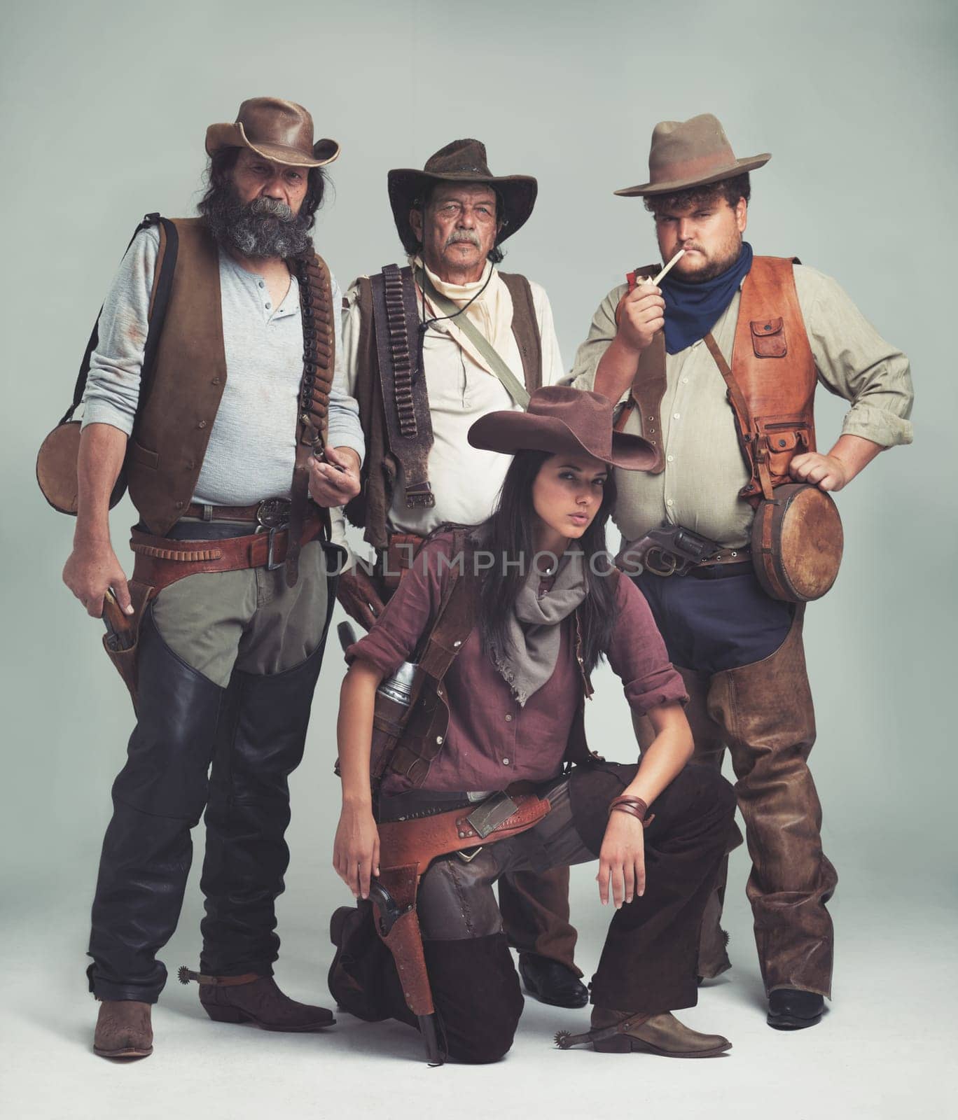 Vintage, western and portrait of cowboy in studio with fashion for halloween, costume and character. Man, woman and group of people with confidence for criminal, band and outlaw lifestyle together.